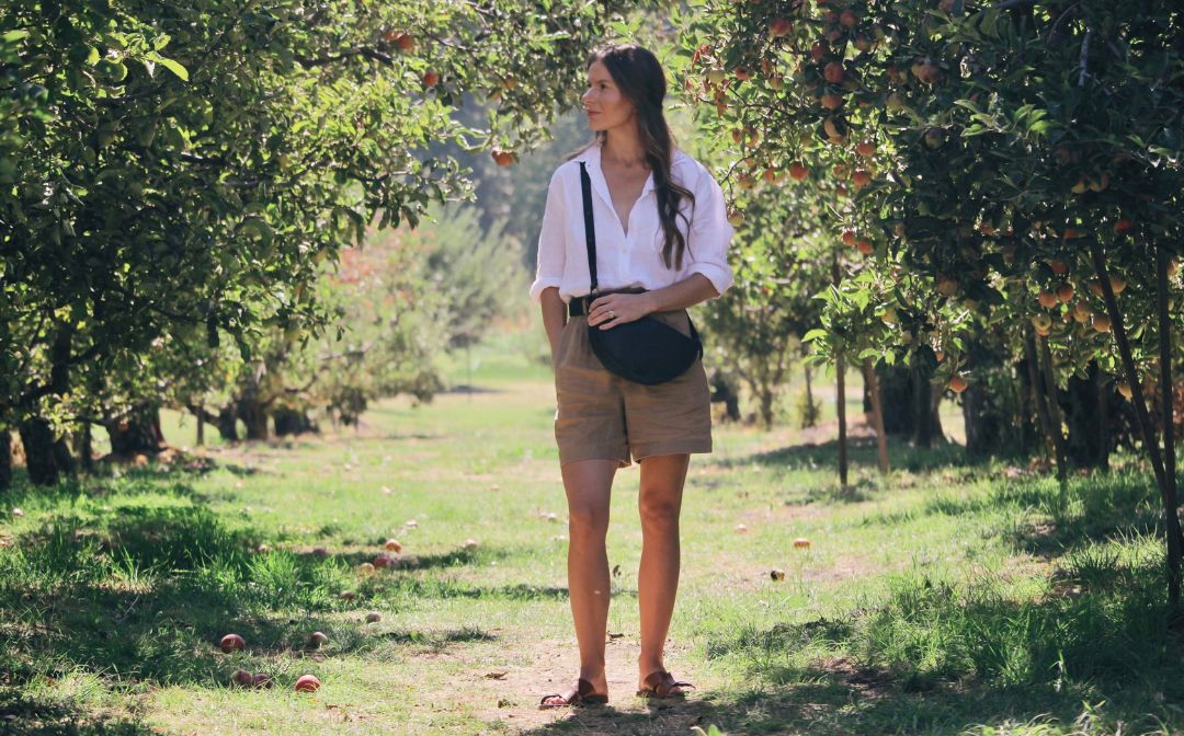 Woman wearing minimalist accessories highlighting slow fashion